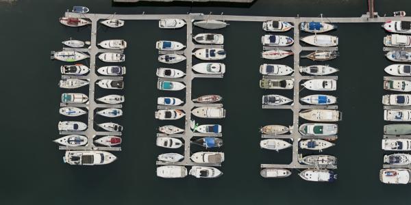Drone shot of boats moored in the marina in the Thea Foss Waterway in Tacoma, Washington on a cloudy day.