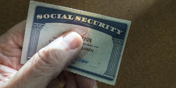 Person holding social security card.